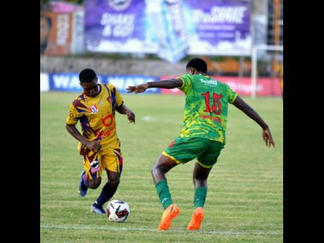 STATHS player Leon Brown is tackled by Excelsior’s Damar Edwards during an ISSA/Digicel Manning Cup game at the Anthony Spauldings Sports Complex on September 30.