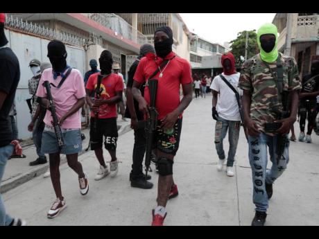 Armed members of ‘G9 and Family’ march in a protest against Haitian Prime Minister Ariel Henry in Port-au-Prince, Haiti. 