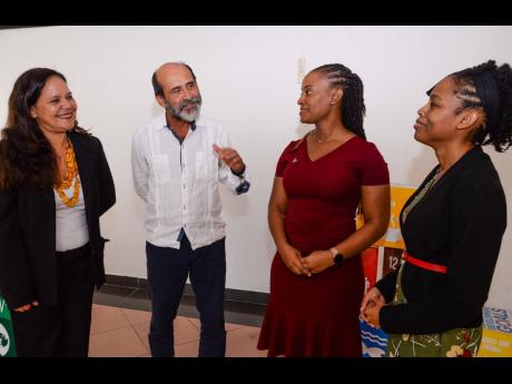 Food and Agriculture Organization of the United Nations (FAO) Representative for Jamaica, The Bahamas, and Belize, Dr Crispim Moreira (second left), makes a point during a conversation with (from left) Dr Inessa Salomao, international consultant with the F