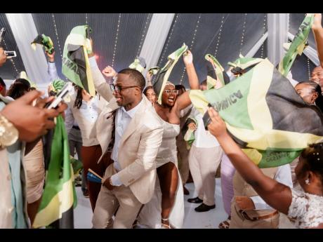 A time was had at the Dusauzays’ reception which, according to the newly-weds, quickly turned into a flag-waving carnival as members of the family united to party.