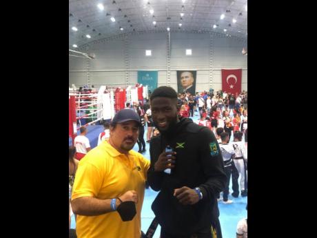 Coach Jason McKay (left) with Akino Lindsay, who, along with fellow Jamaican fighters Nicholas Dusard and Richard Stone, each won double individual gold medals at the October 18-22 International Sport Kickboxing Association’s Amateur Members Association 