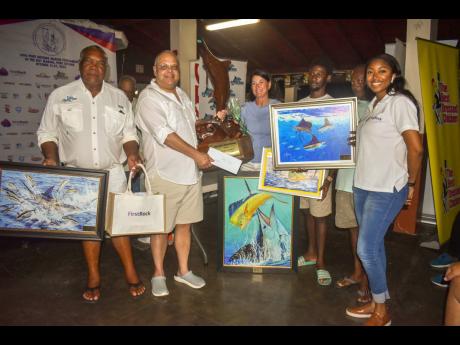 From left: Anthony Richards (Captain) of Bye Pass with his crew, Mark Myers with trophy, Karen Myers, Dwayne Smith, George Wilson and Sable-Joy McLaren, FirstRock Group, group marketing manager.