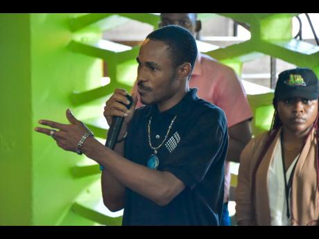 Participant in the Project STAR (Social Transformation and Renewal) initiative, Kristoff James, recounts his involvement in the programme during a tour of Parade Gardens in downtown Kingston recently. 