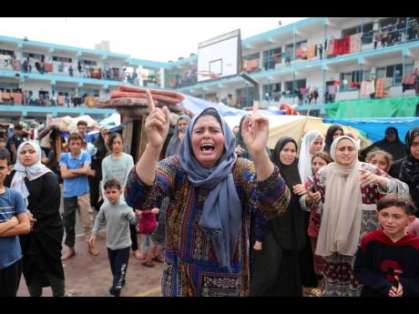 Palestinians mourn a child killed in the Israeli bombardment of the Gaza Strip during his funeral at a UN-run school in Deir al Balah, Gaza Strip.Palestinians mourn a child killed in the Israeli bombardment of the Gaza Strip during his funeral at a UN-run 