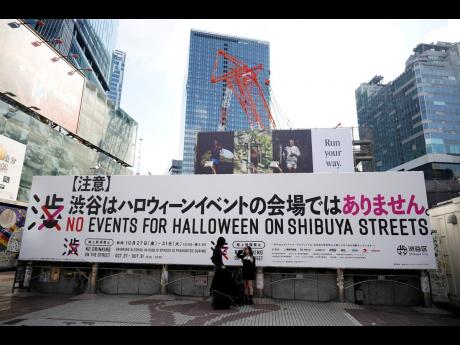Banners across town say no drinking and no Halloween events on the street, and town officials are cordoning off the landmark statue of Hachi with protective walls