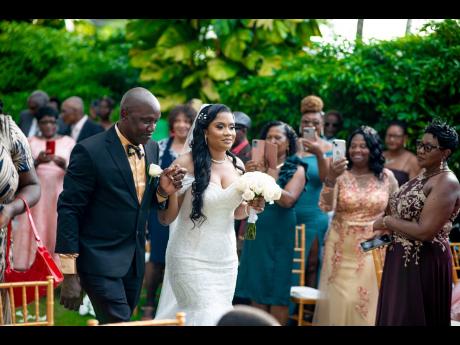 The beautiful bride is happy to be escorted up the aisle by her loving father, Simon Greene.