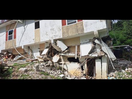 Credit: Gareth Davis A section of the three-storey house damaged after by earthquake at Content in Hope Bay, Portland yesterday.