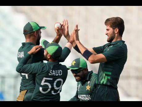 Pakistan’s Shaheen Afridi (right), celebrates the wicket of Bangladesh’s Najmul Hossain Shanto with teammates during an ICC Men’s Cricket World Cup match in Kolkata, India yesterday.