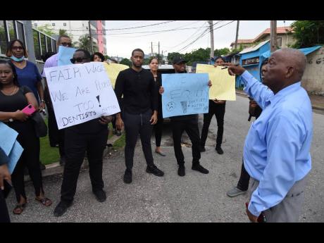 Ian Allen
Vincent Morrison (left), president of the Union of Clerical Administrative and Supervisory Employees (UCASE), addresses members along with its affilliate Jamaica Association of Dental Surgeons (JADS) members during a protest over  wage benefits o