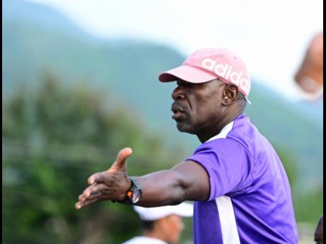 Kingston College coach Vassell Reynolds reacts during an ISSA/Digicel Manning Cup game against Mona High School at the Ashenheim Stadium yesterday.