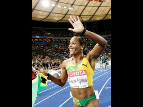 Credit: File Brigitte Foster-Hylton reacts after winning the gold medal in the final of the women’s 100m hurdles at the 2009 World Athletics Championships in Berlin, Germany.