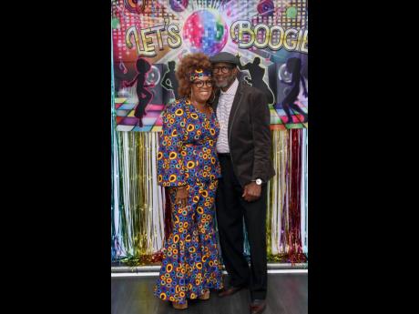 Radiating a 1970s disco queen vibe, birthday girl Sharon Gordon poses with Carl Scott.