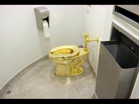 This September 16, 2016 file image made from a video shows the 18-carat toilet, titled ‘America’, in the restroom of the Solomon R. Guggenheim Museum in New York. 