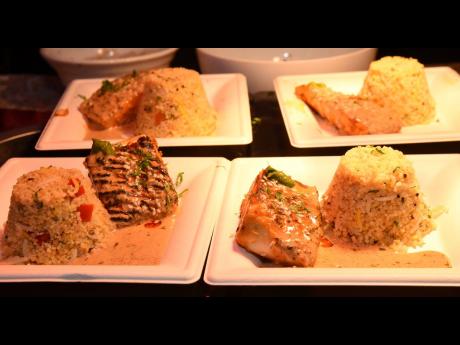 Credit: Ian Allen Harissa spiced Salmon with Cous Cous, Quinoa, rice-pilaf and Tahini Sumac sauce from Chef Vickram Bhandari at Nirvanna Global.
