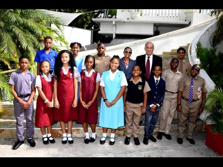 Claudine Allen (third right in back row), general manager of the JN Foundation, and Parris Lyew-Ayee (second right in back row), chairman of the JN Foundation, take a group photo with the 2022 JN Foundation PEP scholarship recipients at last year’s cerem