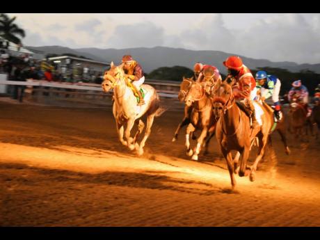 File 
EXCESSIVE FORCE (right), ridden by Bebeto Harvey, wins the inaugural Mouttet Mile Invitational, a three-year-old and upwards overnight allowance stakes ahead of DUKE at Caymanas Park on December 3, 2022.