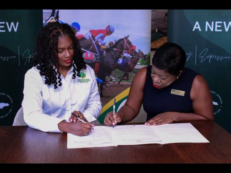 Contributed 
Arielle Beckles, brand optimisation manager at Supreme Ventures Racing and Entertainment Limited (left), joins Marlene Buckridge, sales and marketing manager at ROK Hotel, in cementing a game-changing partnership for the highly anticipated Mou