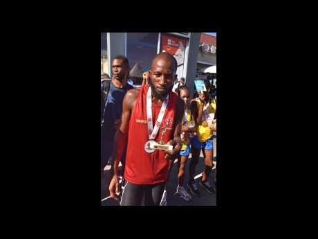 Credit: Nicholas Nunes Dwayne Graham of Rainforest, the overall winner of yesterday’s Burger King 5K which ended at the Portmore Mall in St Catherine yesterday.