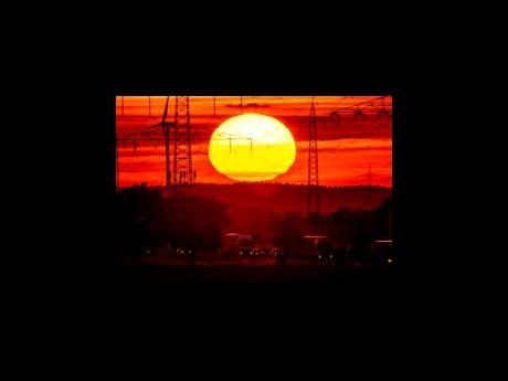 Credit: AP The sun rises above a highway in Frankfurt, Germany, August 2, 2022. Former NASA top scientist James Hansen is warning that global warming is accelerating faster than most models are showing, a contention that other scientists think is overblown. He argues