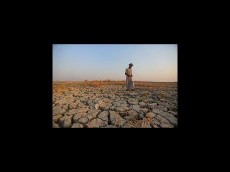 Credit: AP A fisherman walks across a dry patch of land in the marshes in Dhi Qar province, Iraq, in this 2022 photo.