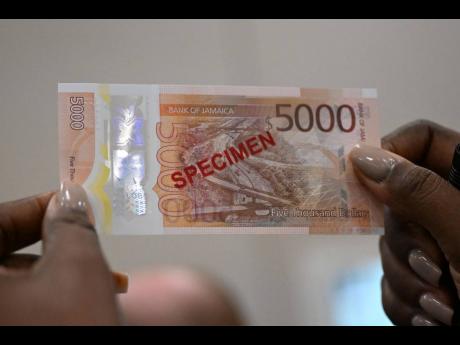 Credit: Gleaner File
A specimen of the $5,000 polymer banknote is displayed at the Bank of Jamaica during the roll-out of the new currency on December 15, 2022.