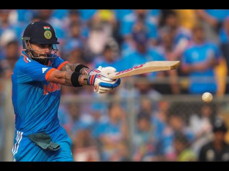 India’s Virat Kohli plays a shot during the ICC Men’s Cricket World Cup first semi-final match against New Zealand in Mumbai, India, on Wednesday.