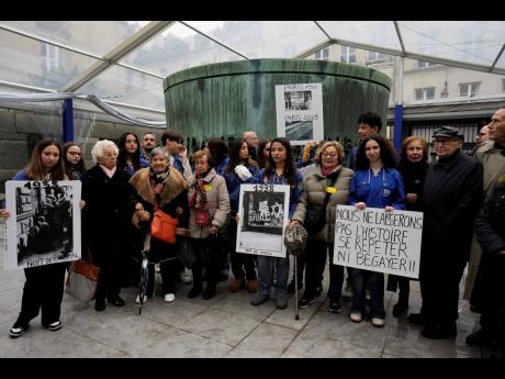 French Nazi hunter Serge Klarsfeld (right) his wife Beata (second from right), and French Holocaust survivors Edith Senot (third from left) and Ginette Kolinka (fifth from left) attend a gathering in the Paris Holocaust Memorial to sound the alarm about re