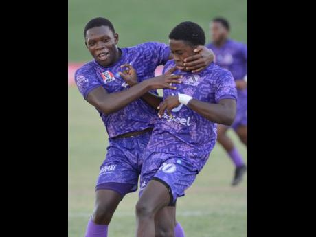 Jaheim McLean (right) got onto the scoresheet in the Champions Cup quarterfinal against Dinthill Technical High School. Celebrating with him in a previous game is is Kimani Reece.