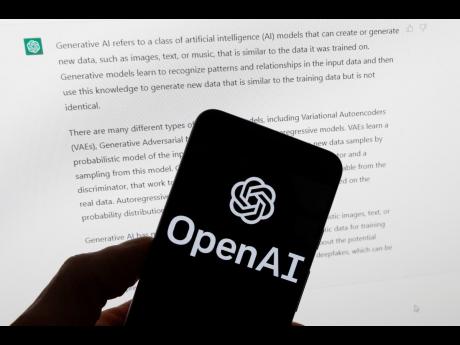 Credit: AP The OpenAI logo is seen on a mobile phone in front of a computer screen displaying output from ChatGPT.