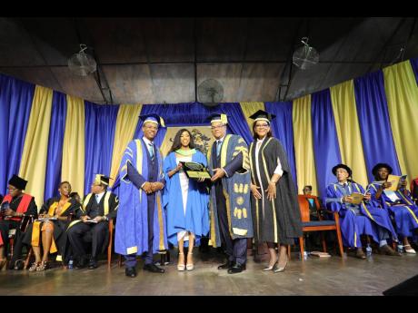 Credit: Contributed Chancellor, University of Technology, Jamaica, Lloyd Carney (second right), is joined by President Dr Kevin Brown (left), and Vice-president and University Registrar Marion Brown (left) in presenting high-achiever Chantelle Britton with the Edward Seaga Aw