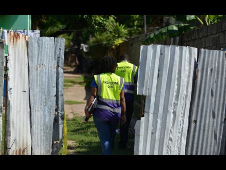 Personnel from the Independent Commission of Investigations arrive at the scene of a shootout in Mountain View, St Andrew, on Monday. One man was shot dead and a soldier wounded during the early-morning operation. 