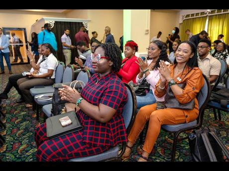 Attendees applaud a presentation at the event.