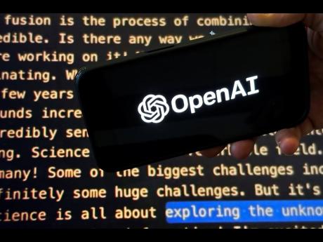 File - The OpenAI logo appears on a mobile phone in front of a screen showing part of the company website in this photo taken on Nov. 21, 2023 in New York. Negotiators will meet this week to hammer out details of European Union artificial intelligence rule