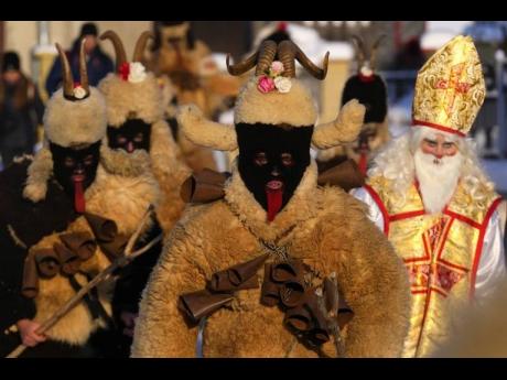 Revellers take part in a traditional St Nicholas procession in the village of Lidecko, Czech Republic, on Monday. This pre-Christmas tradition has survived for centuries in a few villages in the eastern part of the country.