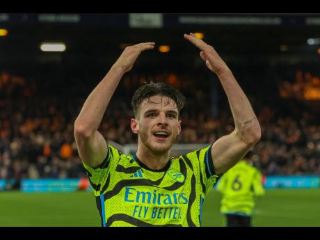 Credit: AP Arsenal’s Declan Rice celebrates after scoring his side’s fourth goal during an English Premier League football match against Luton Town at Kenilworth Road, Luton, England yesterday.