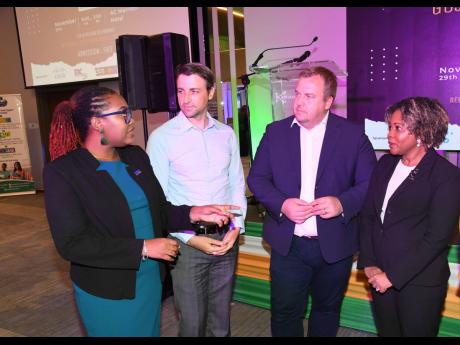 Credit: Contributed Strycen Williams (left), product manager, MC Systems, in discussion with Senator Dr Dana Morris Dixon (right), minister without portfolio in the Office of the Prime Minister with oversight for skills and digital transformation; Siim Seekut (second right),