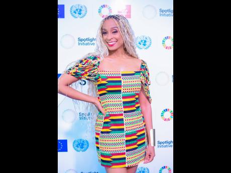 Recording artiste and radio personality Alaine beams with her contagious smile on the purple carpet.