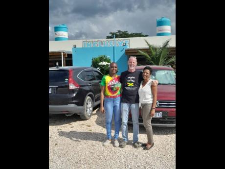 From left: Sheneka Robinson-Wright, project director, TUI Junior Academy Jamaica; Peter Rose, president of The Rockhouse Foundation; and Coral Purvil-Williams, destination programmes manager, TUI Care Foundation, outside of Savanna-la-Mar Inclusive Academy