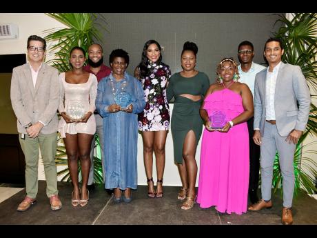 Executives of the Grand Palladium Jamaica Resort and Spa, Gerardo De Groot (left), Merricka Dyer-Cunningham (fifth left) and Lij Keith (right) pose with representatives of their three top travel partners for the hotel in 2023 at their presentation and awar