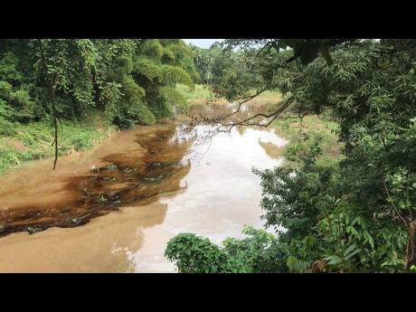 Credit: Photo by Ruddy Mathison A suspected fresh oil spill seen in the Rio Cobre on Friday morning has again irked residents and fisherfolk, who were just starting to hope for a return to normality after efforts to clean-up after a previous spill days ago.
