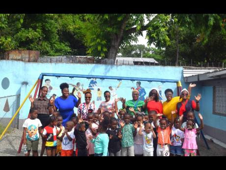 Credit: Contributed The Shipping Association of Jamaica staff with the teachers and students of the Marcus Garvey Basic School during their Christmas treat last Wednesday.