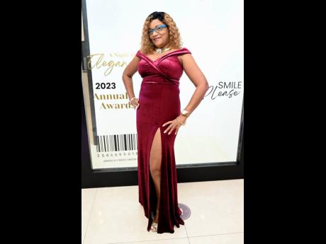 Lavern Johnson, benefits manager of JCCUL, elegantly showcases a red suede dress with a front split.