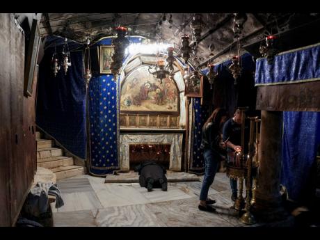 People visit the Grotto, under the Church of the Nativity, traditionally believed to be the birthplace of Jesus Christ in the West Bank town of Bethlehem, Saturday, December 16, 2023. World-famous Christmas celebrations in Bethlehem have been put on hold d