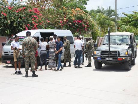 Passengers from a minibus being searched at a checkpoint at Wiltshire in Greenwood, St. James. Gordon Robinson writes: This Government’s use of SOEs as a crime fighting tool is either legal or illegal. If we think they are legal, we should direct our cri