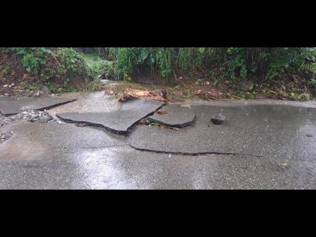 The newly asphalted roadway from Pigdry to Seaman’s Valley in Portland was ripped apart after water from the White Cane River inundated the main thoroughfare.