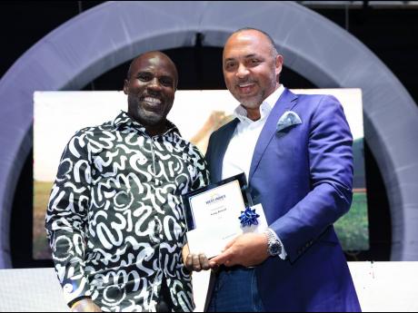  Charles Chambers presents the Long Service Award to employee Greg Powell (left).