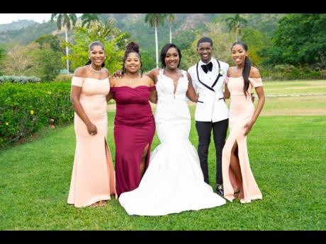Credit: Contributed Danaia (centre) and husband, Jahzeal, pose with the bride’s tribe (from left) Saskia Dawkins, Saniqua Roberts, and Daydree Thomas.