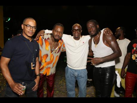 Yush organisers Scott Dunn (left) and Phillip ‘PP’ Palmer (second right) strike a pose with entertainers Govana and Aidonia (right) after their performances.