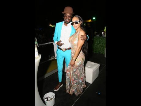 Dapper in a blue suit from Enigma, Beenie Man and the lovely Camille Davis strike a pose.