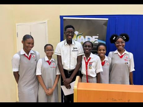 Deputy programmes manager for Jamaican Association for Debating and Empowerment (JADE) Limited, Xavier McFarlane, with members of the debating team of The Queen’s School in Kingston, after adjudicating in the ‘A Fi Wi Republic’ Secondary School Debat